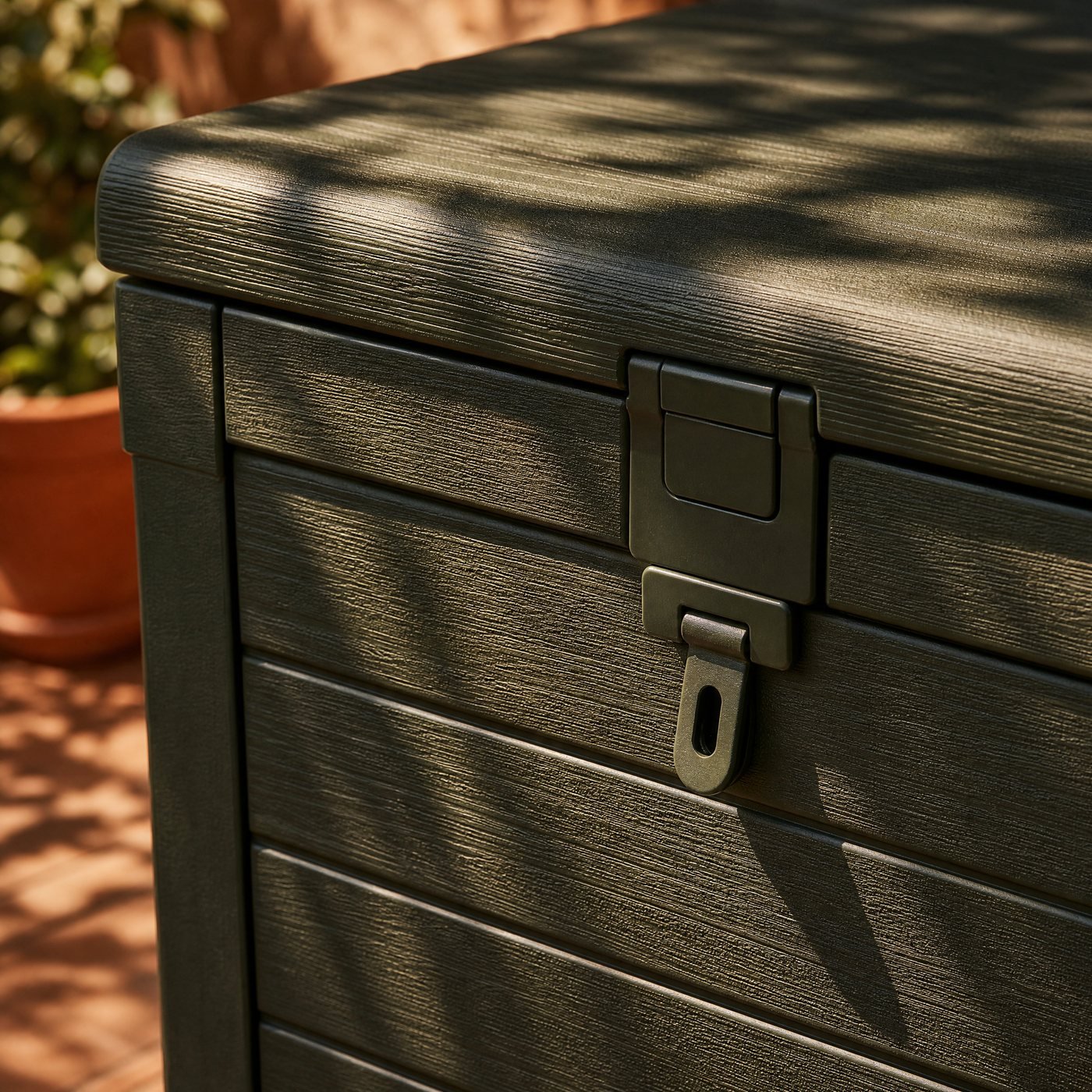 Deck Storage Box, 120 L — detail of the wood-grain texture of the plastic and the lid hasp