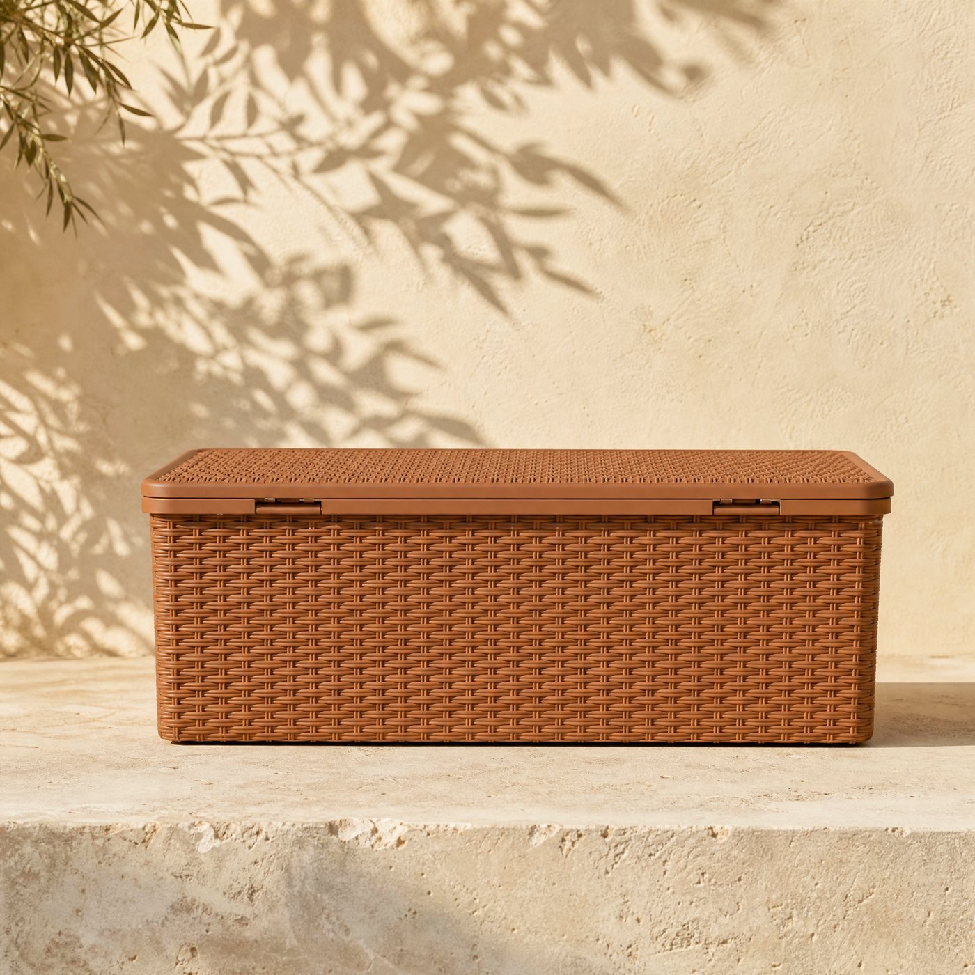 Balcony Storage Box, 70 L — a slim rectangular terracotta-brown polypropylene storage box with a woven rattan-look texture and hinged lid, closed