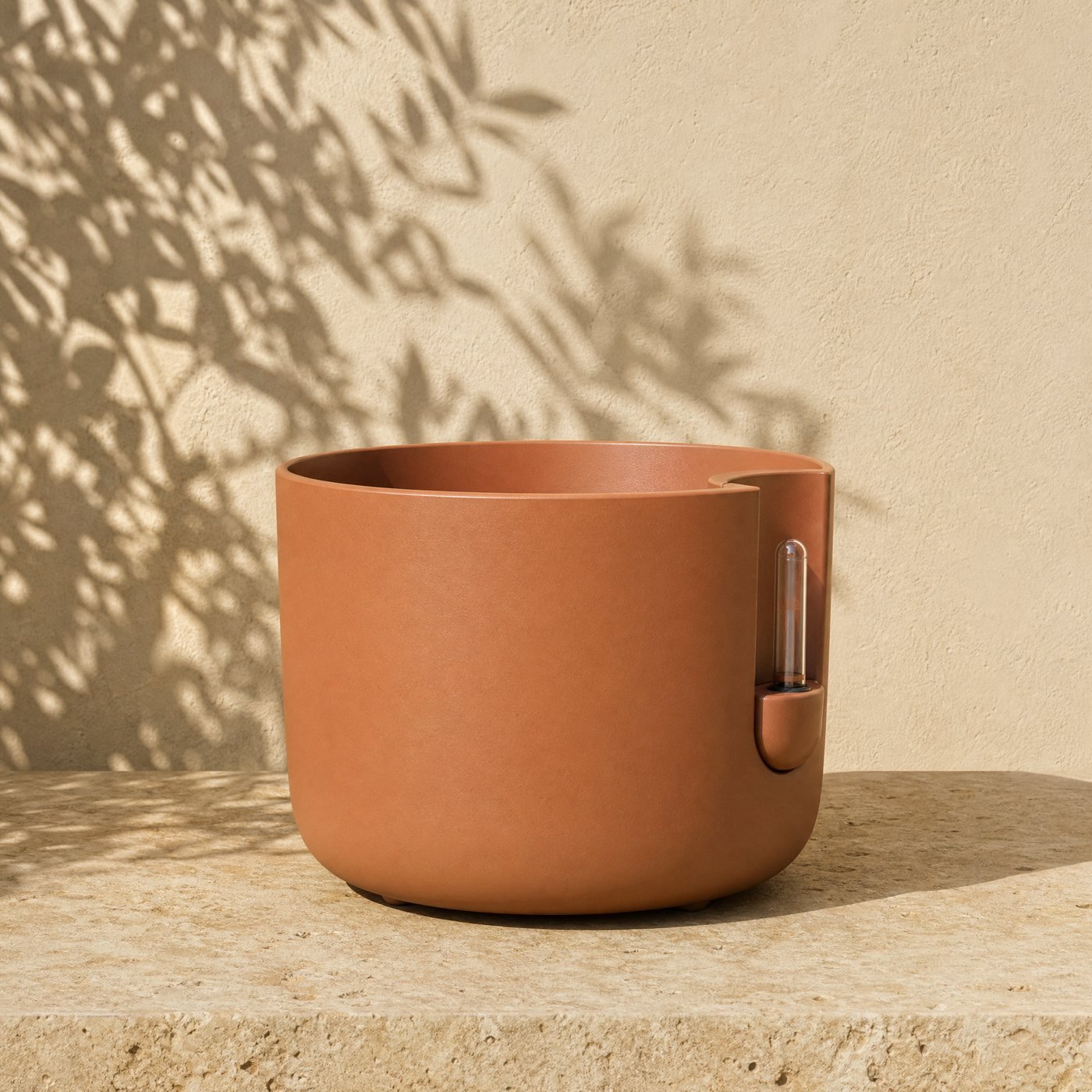 Self-Watering Planter, 30 cm — a round matt clay-coloured polypropylene self-watering planter 30 cm across with a small fill spout and a water-level float on its side, empty