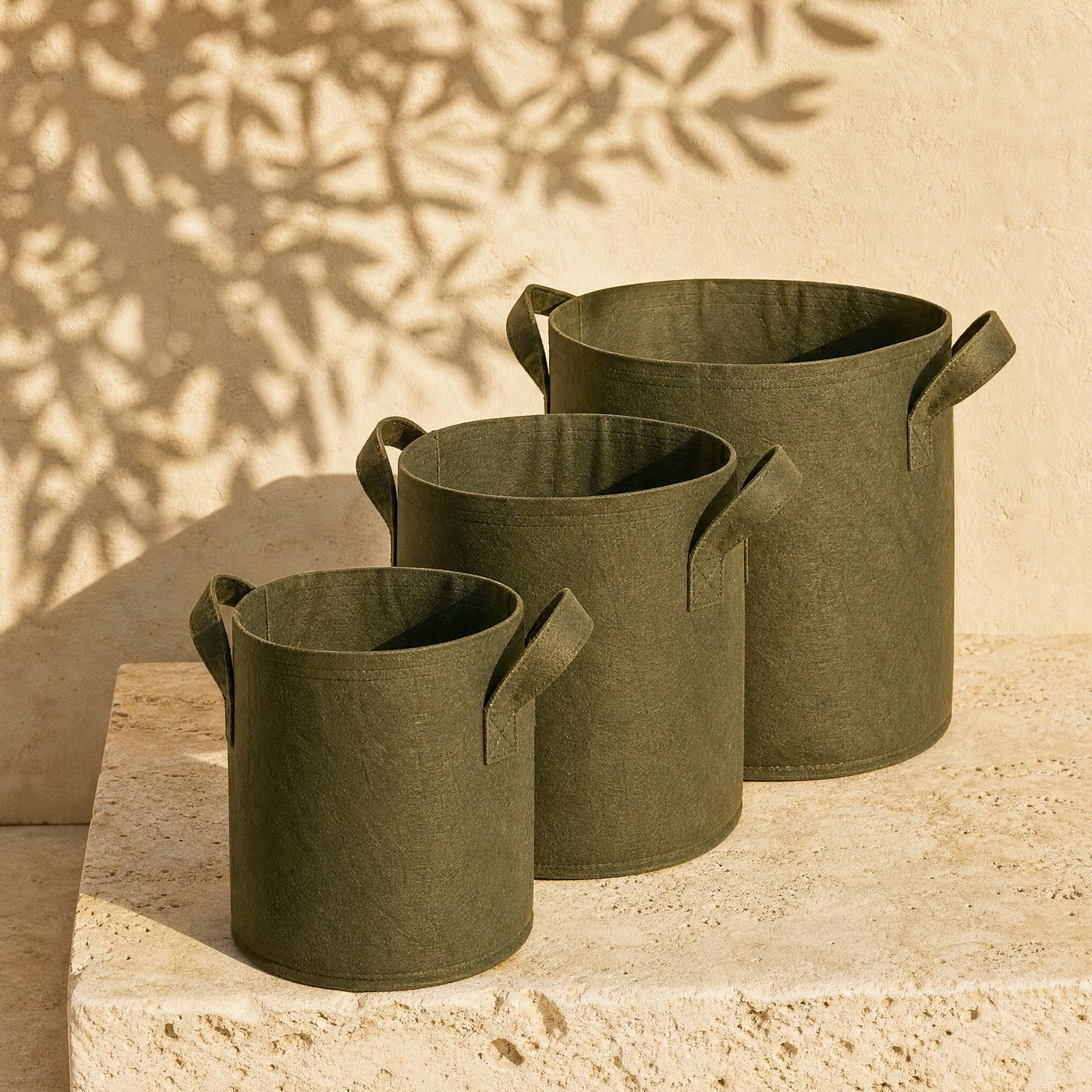Non-woven Grow Bags, Set of 3 — three dark olive-green non-woven fabric grow bags with sewn handles, standing open and empty, one in front of the other