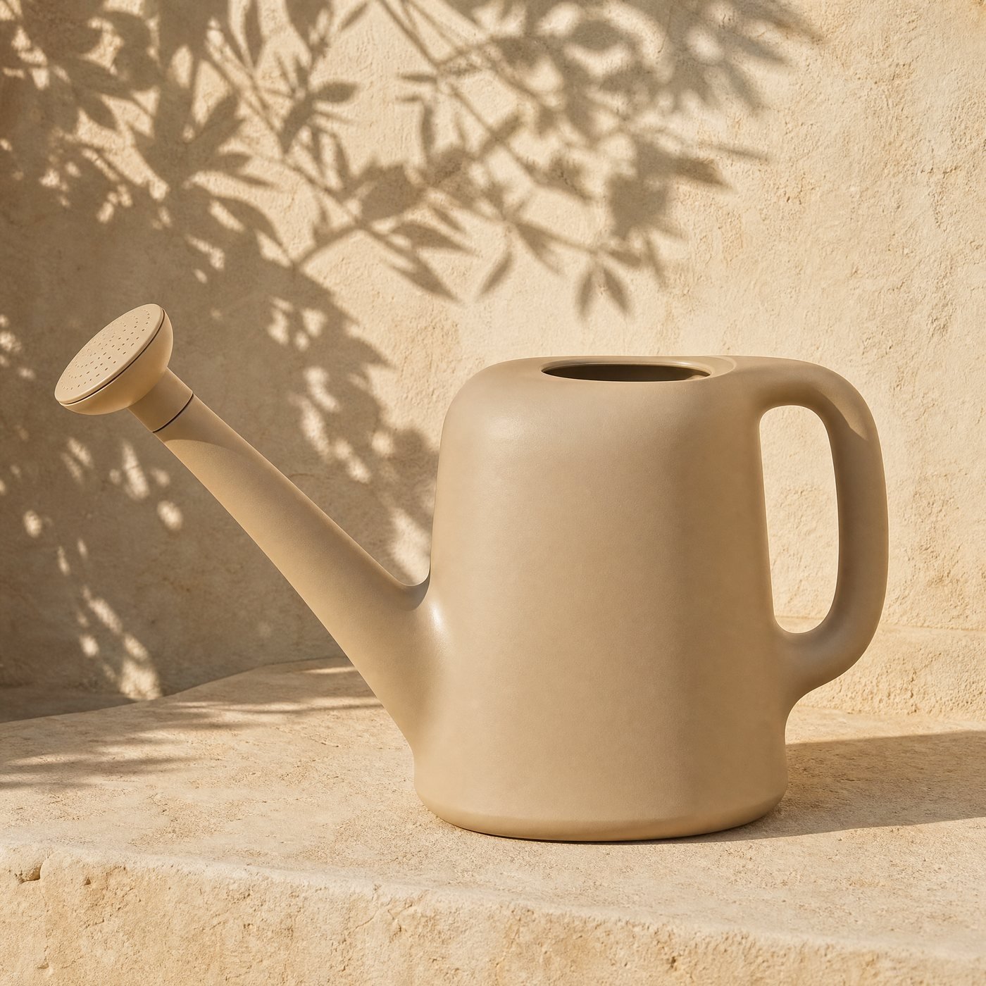 Watering Can with Rose, 5 L — a medium oat-beige matt PE watering can with a detachable oval rose, 5 litre, standing on sunlit stone